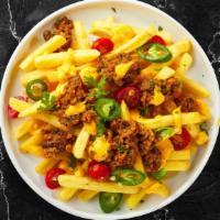 Chili Cheese Fries · Fries cooked until golden brown and garnished with salt, melted cheddar cheese, and chili sa...