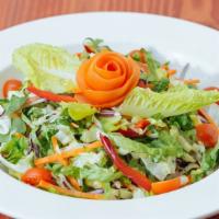 Garden Salad · Shredded lettuce, red cabbage, bell peppers, carrots, tomatoes, onions, and olives with a si...