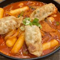 Spicy Rice Cake · Spicy rice cake with vegetables and fried dumplings.