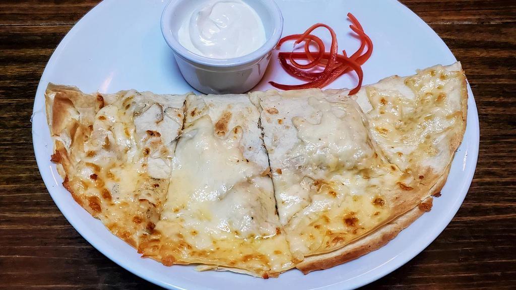 Cheese Quesadilla · Toasted flour tortilla stuffed with Monterey, Oaxaca & Chihuahua cheeses. Served with salsa verde and chipotle crema.