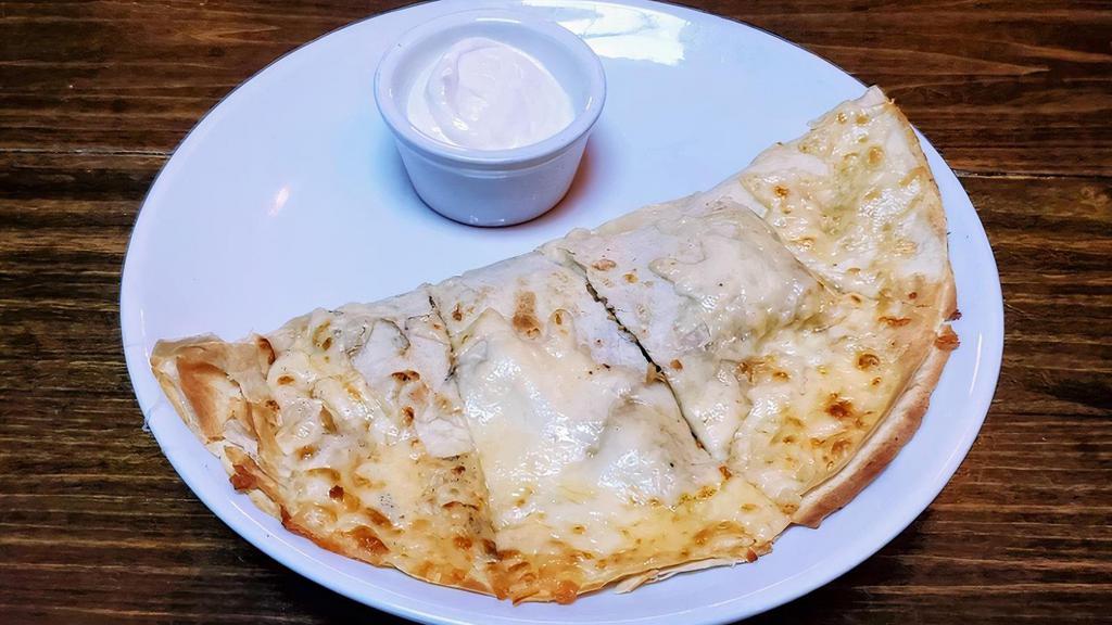 Wild Mushroom Quesadilla · Toasted flour tortilla stuffed with Monterey, Oaxaca & Chihuahua cheeses. Served with salsa verde and chipotle crema.