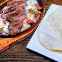 Steak Fajitas · Grilled onion, red & green peppers, Oaxaca cheese & corn tortillas. Served with white rice.