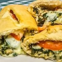 The Chicken Florentine Stromboli · We brush the inside of our stromboli dough with garlic butter and fill it with roasted chick...