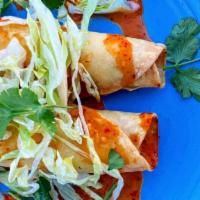 Spicy Crab Taquito · Crispy rolled taco filled with cream cheese, roasted garlic, scallion and crab meat. Topped ...