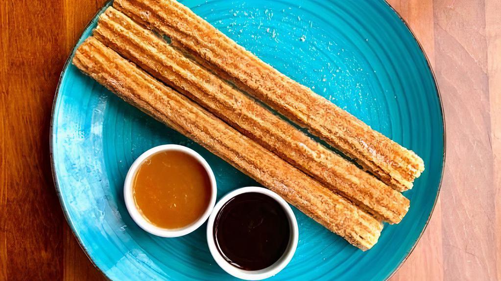 Spanish Churros · Cinnamon Sugar dusted Churros. Served with Chocolate and Caramel dipping sauce.