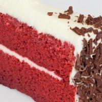 Red Velvet Cake · Double-layered Red Velvet Cake topped with Cream Cheese Icing and Chocolate Curls.