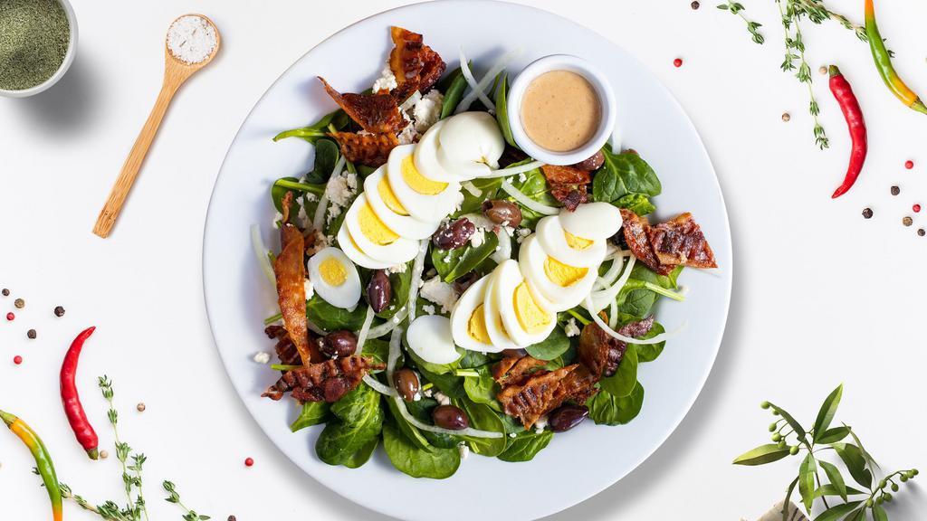 Spin It Spinach Salad · Spinach, feta, bacon, onion, olives, and two hard-boiled eggs tossed with house dressing.