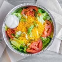 Garden Salad · Lettuce, tomato, shredded cheese, onions, and dressing.