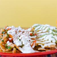 Loaded Nachos · Topped with melted cheese, beans, guacamole, pico de gallo and sour cream.