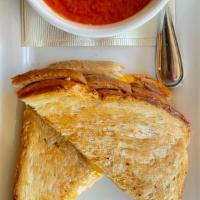 Grilled Cheese And Tomato Soup · grilled sourdough, american, cheddar and jack cheeses, house made tomato soup.