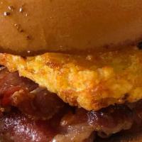 The Hashbrowner · Breakfast Sandwich topped with our great hashbrown