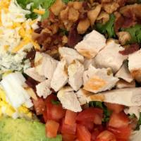 Cobb Salad · Crisp organic greens with tender sliced chicken breast, apple wood bacon, ripe tomatoes, har...
