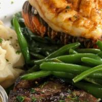 Surf N Turf · Petit filet mignon on demi wine sauce paired with a sweet six ounce lobster tail and served ...