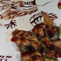 Tokyo Dragon Roll · Shrimp tempura, cucumber inside, eel, avocado and tobiko on top with eel sauce.