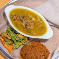 Doro Wot · Spicy, boneless chicken stew simmered in a hearty chili pepper sauce, spiced butter, w/hard-...