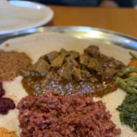 Kitfo · Lean minced beef marinated in bird's eye chili-peppers blend & spiced clarified butter
