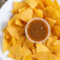 Chips & Salsa · Spicy, Vegan, Vegetarian. Fresh made corn tortilla served with our house-made salsa serrano.