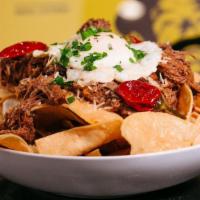 Beef Nachos · Black beans, black olives, queso, pico de gallo and jalapenos.