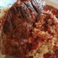 Short Ribs · Braised boneless short ribs, in a chianti and tomato sauce served over  parmesan risotto
