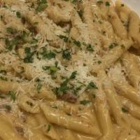 Penne Vodka · Braised prosciutto in a pink cream sauce with a touch of vodka.