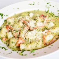 Gnocchi Stefano · Homemade bistro gnocchi served with basil pesto cream sauce and roasted peppers.