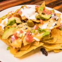 Nachos · Cheese covered Nachos Loaded with Pico de Gallo, Black Beans, Jalapenos, Guacamole, and Sour...