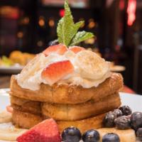 Cap'N Crunch French Toast · Topped with Banana, Mixed Berries, Whipped Cream, Cinnamon, and Powdered Sugar. Served with ...