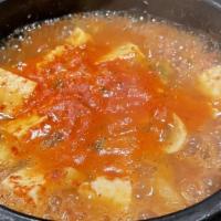  Kimchi Jigae/김치찌게 · Hot & spicy. Kimchi and sliced pork stew with vegetables and tofu.