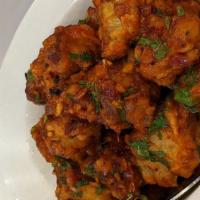 Gobhi Manchurian · Crispy fried cauliflower pieces, garlic, ginger, onion, tomato and tossed with soya base sau...