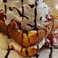 Strawberry Cheesecake Stuffed French Toast · 3 pieces of Texas French Toast, filled with cream cheese frosting, topped with strawberries