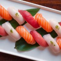 Triple Sashimi Delight · Four pieces tuna, four pieces salmon, four pieces yellowtail.