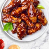 Bbq Chicken Wings · Fresh chicken wings fried until golden brown, and tossed in barbecue sauce. Served with a si...