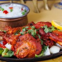 Tandoori Chicken · Chicken leg marinated with yogurt, ginger, garlic, and other Indian spices baked in tandoor ...