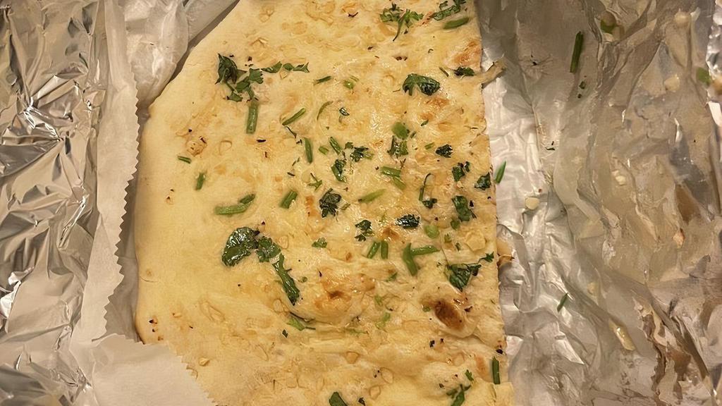 Garlic Naan · Indian bread stuffed in garlic and cilantro baked in tandoor.