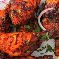 Tandoori Chicken (Half) · Grilled bone-in chicken marinated in yogurt, garlic, ginger & fresh ground spices