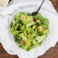 Caesar Salad · Romaine lettuce tossed with a creamy caesar dressing, croutons, and Romano cheese.