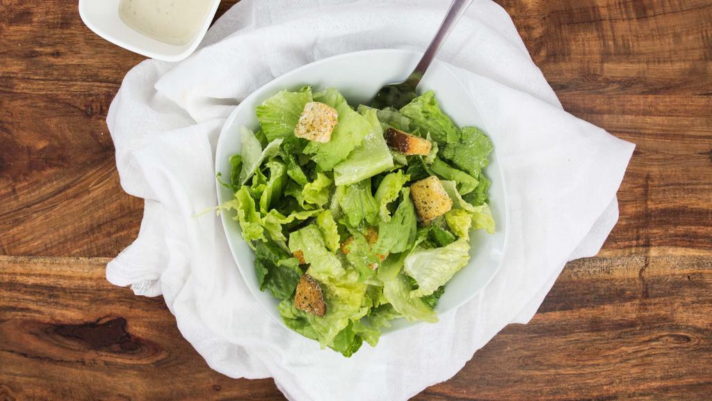 Caesar Salad · Romaine lettuce tossed with a creamy caesar dressing, croutons, and Romano cheese.