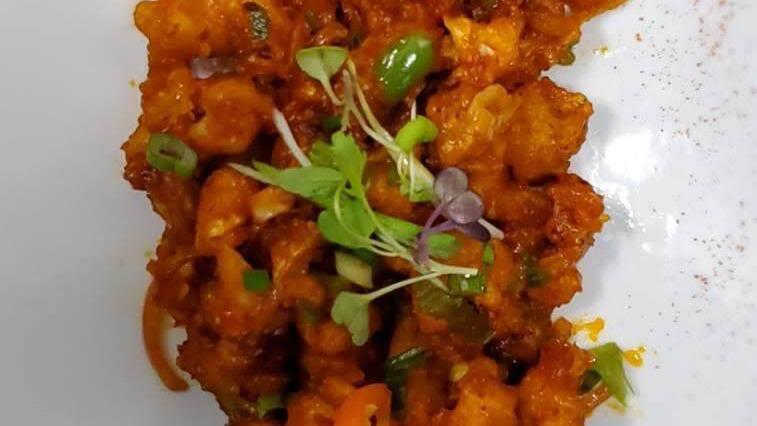Gobi Manchurian · Vegan. Cauliflower florets sautéed in a spicy and tangy sauce and prepared in an Indo-Chinese style.