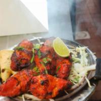 Tandoori Wings · Gluten-free. Chicken wings marinated with ginger, garlic, chili, and garam masala and grille...