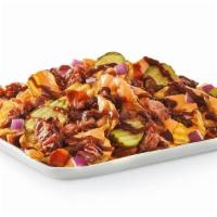 Smothered Bbq Brisket Chips · Yukon Chips topped with beer cheese sauce, chopped smoked brisket, hardwood smoked bacon, di...