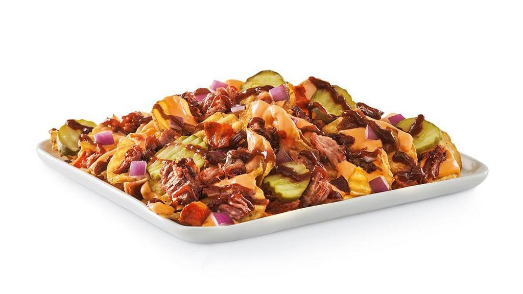 Smothered Bbq Brisket Chips · Yukon Chips topped with beer cheese sauce, chopped smoked brisket, hardwood smoked bacon, diced red onions, dill pickles and drizzled with Whiskey River BBQ Sauce.  Or try it with Steak Fries!