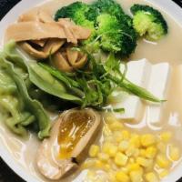 Veggie Ramen  · Miso veggie broth thin straight noodles topped with firm tofu veggie dumplings corn bamboo s...