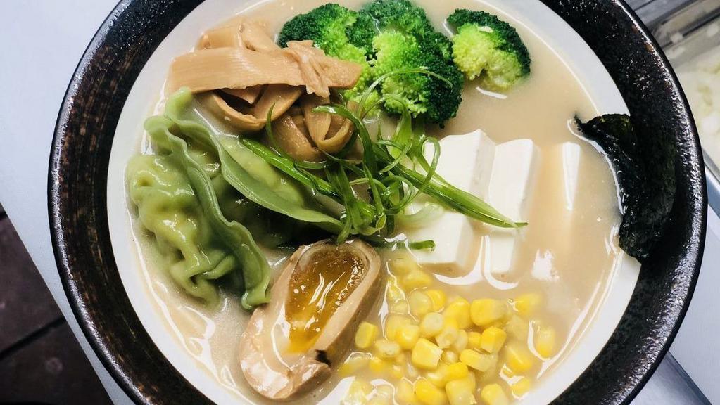 Veggie Ramen · Vegetarian. Miso veggie broth, veggie noodle, topped with firm tofu, veggie dumplings, corn, bamboo shoot, scallion, and seasoned boiled egg.