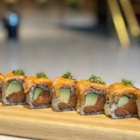 Sunset Roll · Salmon avocado roll topped with seared seasoned salmon, spicy mayo and micro greens.
