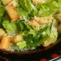 Caesar Salad · Crispy romaine lettuce, Parmesan cheese, homemade croutons and Caesar dressing.