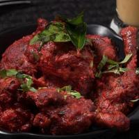 Chicken Lollipop · Marinated chicken wings deep fried sauteed with spices and herbs.