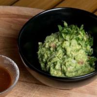 Guacamole · Our hand-crushed classic guacamole served with house-made chips and pasilla de Oaxaca salsa.