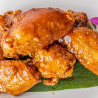 Thai Herb Wing (6 Pieces) · Deep-fried Thai herb-marinated chicken wing with homemade sunrise sauce.