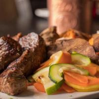 Lu Steak Tips · Marinated tips served with mashed potato and roasted seasonal vegetable