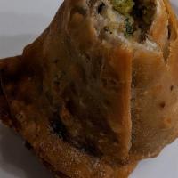 Vegetable Samosas · Lightly spiced potatoes and peas wrapped in pastry dough and deep fried (2 per order)